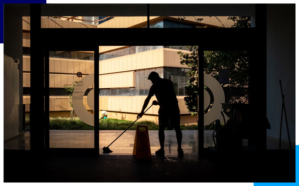 A commercial business cleaner efficiently mopping a shiny floor, showcasing meticulous cleaning standards.