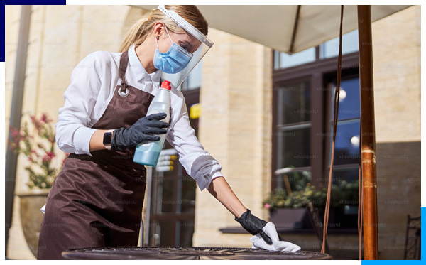 A team of professional commercial cleaners in branded uniforms diligently clean an a commercial property.
